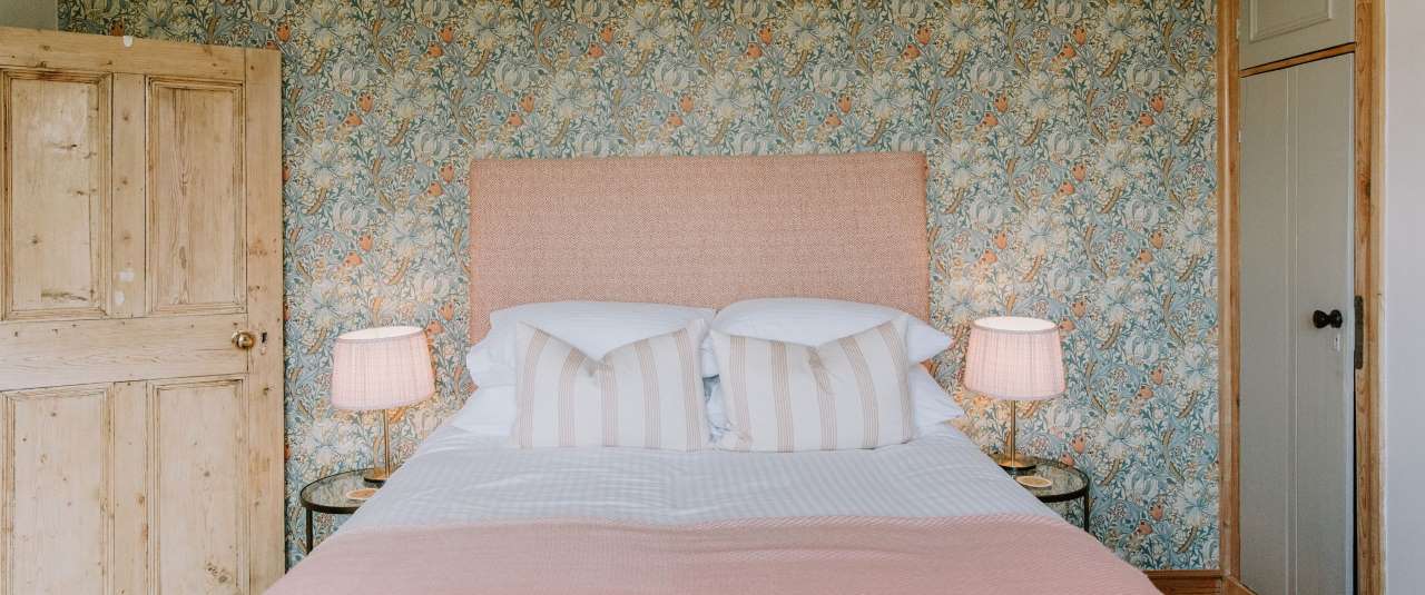 luxurious bedroom at the farmhouse with william morris golden lily wallpaper