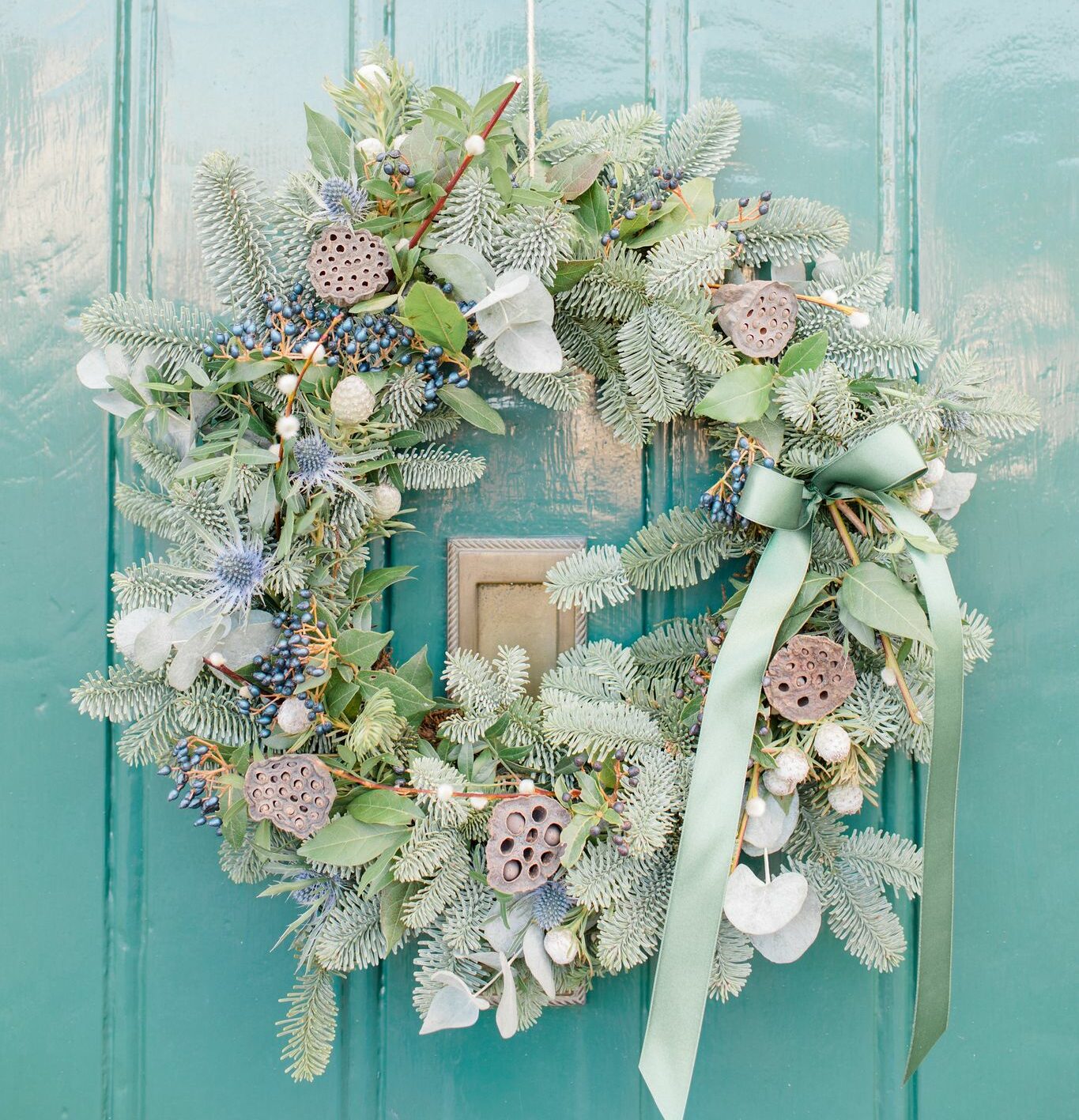 A luxury Christmas wreath crafted with fresh foliage, festive accents, and elegant ribbons, beautifully displayed to evoke the warmth and magic of Christmas at The Farmhouse at Polehanger.